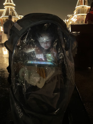 My son waiting for fireworks. He's enclosed in a rain shield over his stroller and playing with his iPad.