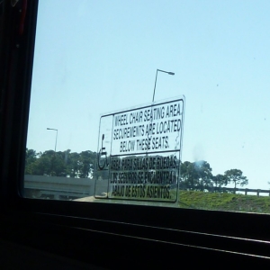 Bus sign above wheelchair spots