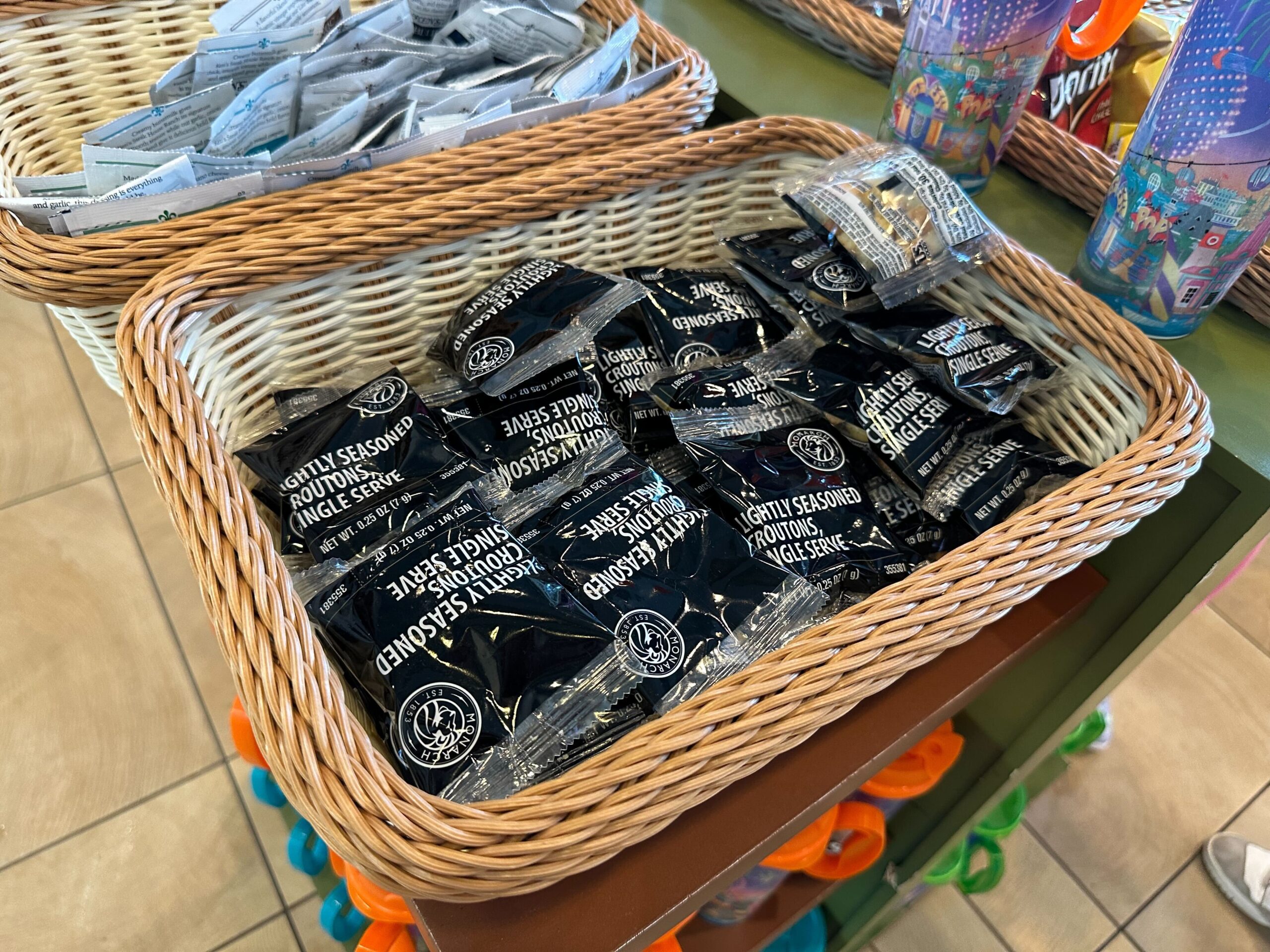 A basket filled with single-serve packets of seasoned seaweed in a store display.